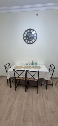 Glass dining table with 4 metal-frame chairs - good condition