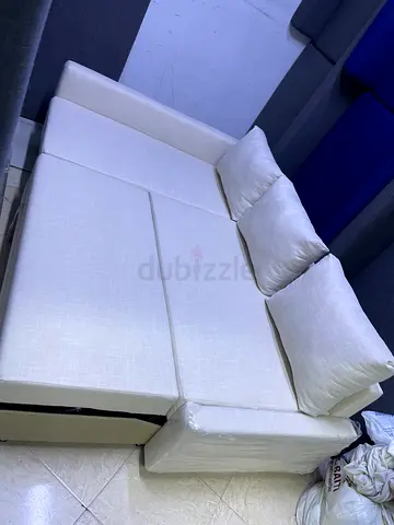 Comfortable White L-Shape Sofa Bed with Cushions