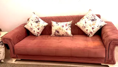 Urgent sale 3-seater pink velvet sofa with floral cushions - good condition