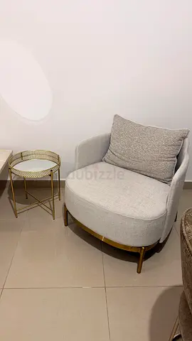 Light grey upholstered accent chair with cushion