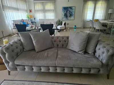 Gray tufted 3-seater sofa in very good condition...1 year old from Huzaifa original price Aed7,800