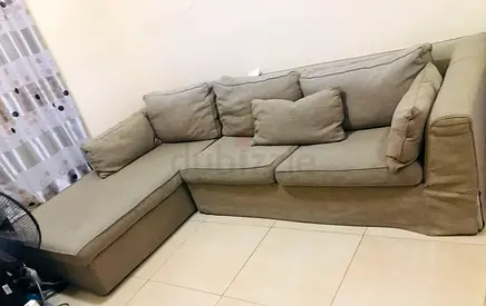 L-shaped beige fabric sofa with chaise - good condition