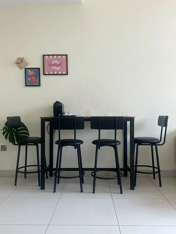 Simple black dining table with 4 matching stools