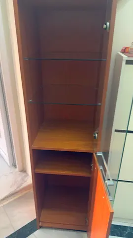 Tall wooden storage cabinet with glass shelves - good condition