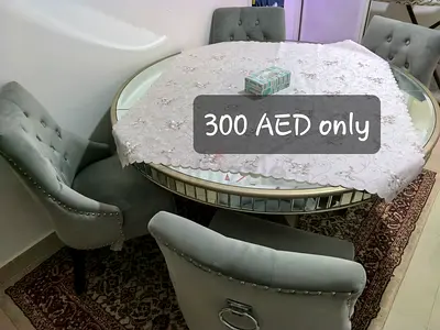 Round Glass Dining Table with 4 Upholstered Chairs - Used, AED 300