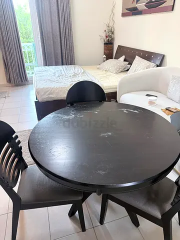 Used round wooden dining table with 3 chairs - dark finish
