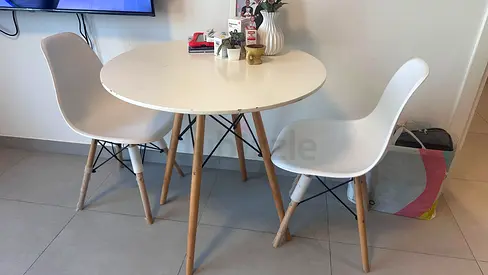 Small round dining table with 2 modern white chairs