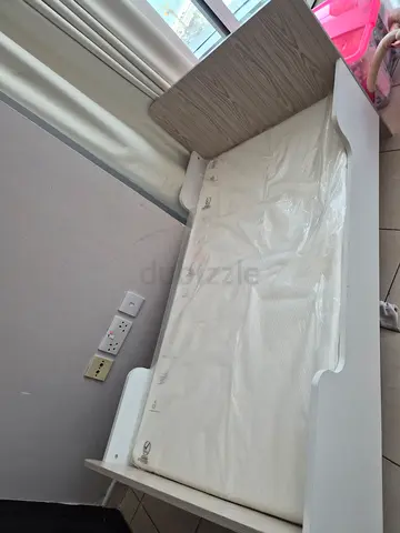 White baby changing table with storage shelf — good condition
