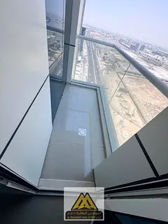 Two bedrooms and a living room with a balcony offering an open view, located in the Mushrif area opp