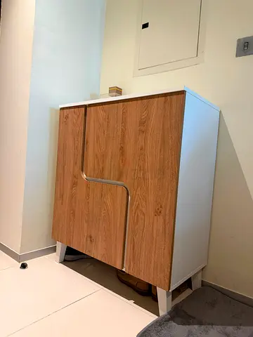 Compact wooden storage cabinet with white frame - good condition