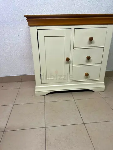 Small cream wooden cabinet with 1 door and 3 drawers