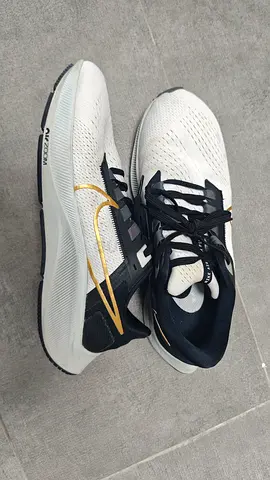 Used Nike Running Shoes - White/Black with Gold Swoosh, Size Unknown