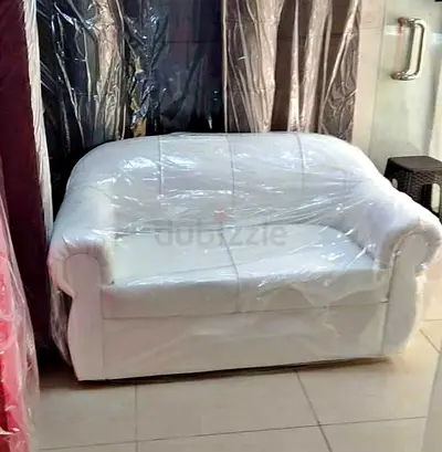 Two-seater white leatherette sofa in good condition available in every color