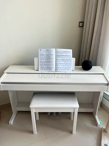White digital piano with bench - compact upright style