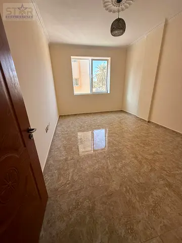One-bedroom apartment with a lounge for annual rent in Al-Rashidiya 2