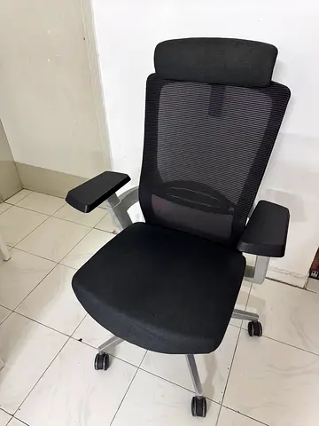 Ergonomic black office chair with headrest and armrests