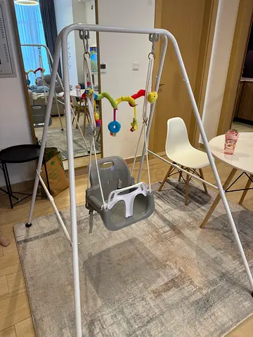 Sturdy Baby Swing with Safety Harness and Activity Toy