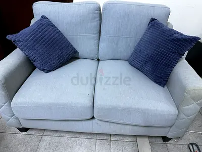 Light grey 2-seater sofa in good condition with cushions