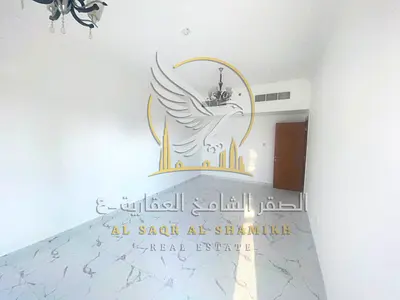 Annual rental apartment in Al Nakheel with two bedrooms, living room, two balconies, three bathrooms and private parking near Lulu Market.