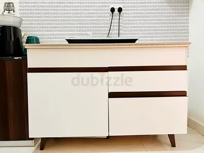 Compact white cabinet with drawers and countertop