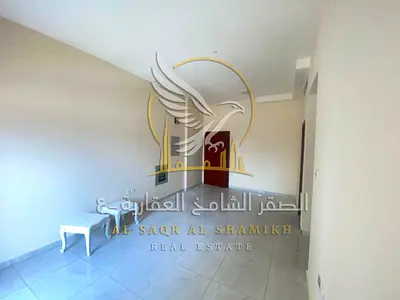 For annual rent in Al Rashidiya 2 Ajman a two-bedroom apartment with a living room two bathrooms a balcony with an open view central air conditioning