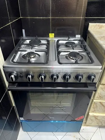 4-burner Gas Stove with Oven - Stainless Steel, used for less than a year and under warranty