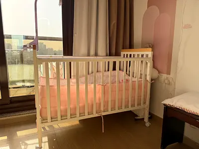 White wooden baby crib with mattress and bumpers - good condition