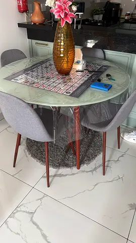 Round glass dining table with 4 grey upholstered chairs - excellent condition
