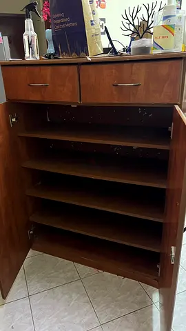 Wooden storage cabinet with multiple shelves and two drawers