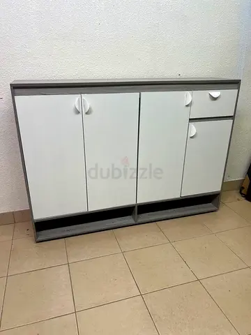 Compact white and grey storage cabinet with doors and drawer