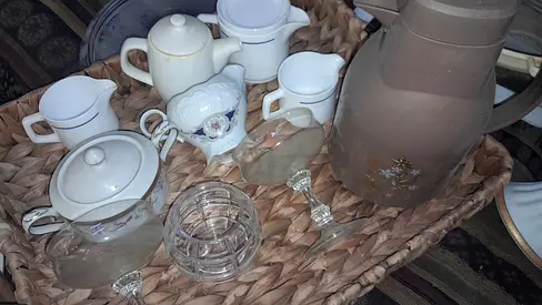 Assorted tea set  glassware on woven serving tray - used