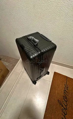 Rimova trunk plus black luggage