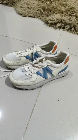 White sneakers with blue accents, lightly used - size not specified