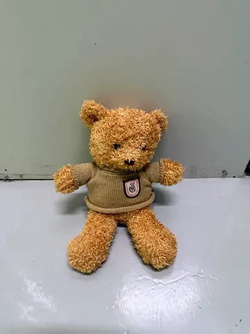 Small plush teddy bear in beige sweater - good condition