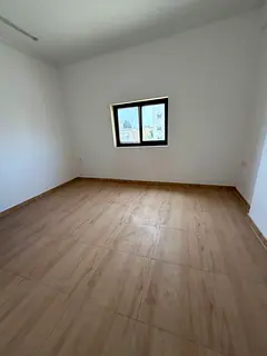 For annual rent in Al Mowaihat 3, near the school complex: Brand-new two-bedroom apartment with a li