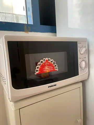 Compact white Midea microwave oven with mechanical controls - good condition