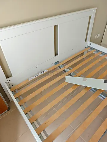White wooden double bed frame with slatted base