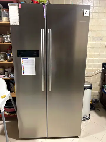 Large stainless steel side-by-side fridge in good working condition