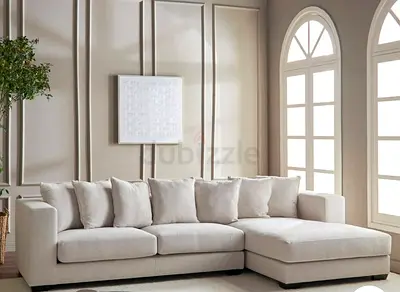 Light beige L-shaped sectional sofa with chaise and ottoman