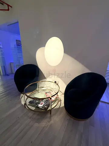 Pair of modern swivel lounge chairs with glass coffee table
