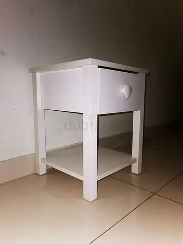 White wooden bedside table with single drawer and shelf