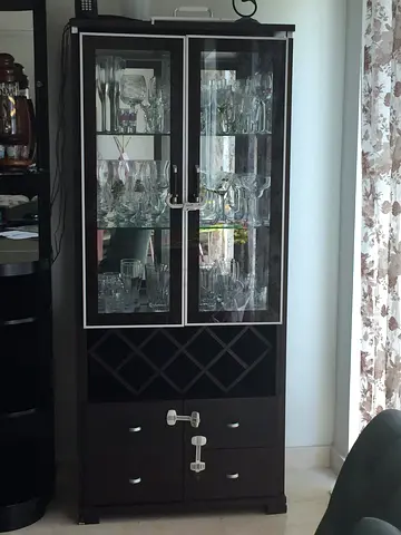 Dark wood display cabinet with glass doors and wine rack