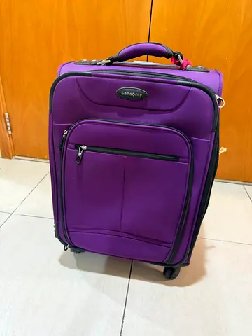 Purple Samsonite carry-on suitcase with wheels - good condition