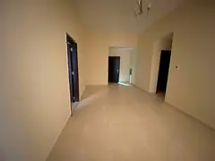 Two-bedroom apartment with a living room, two bathrooms, and a balcony, located in Al Jurf 2, close