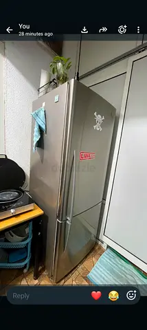 Silver double-door refrigerator in good working condition