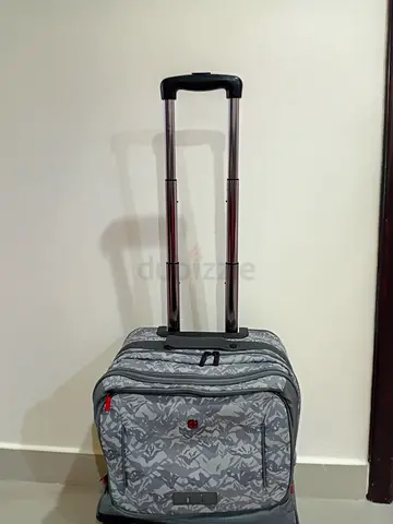 Lightweight grey patterned rolling carry-on backpack with extendable handle