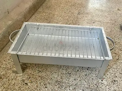 Portable metal charcoal grill with removable rack