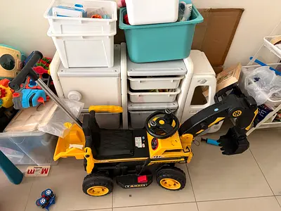 Kids ride-on excavator digger toy with moving arm and bucket with parental remote control.