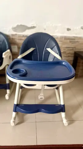 Blue baby high chair with tray and safety straps