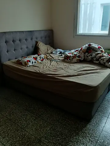 Grey upholstered double bed with headboard - good condition
